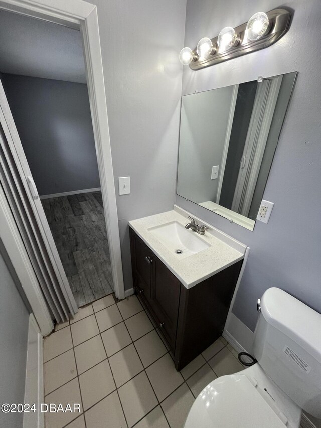 506 Cambridge Cir S, Daytona, FL 32119 - half bathroom featuring vanity and tile patterned flooring