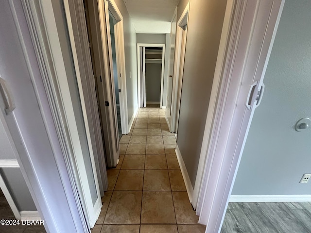 hallway with light tile patterned floors