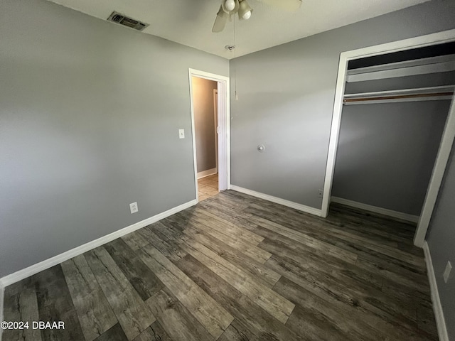 506 Cambridge Cir S, Daytona, FL 32119 - unfurnished bedroom featuring dark wood-type flooring, a closet, and ceiling fan