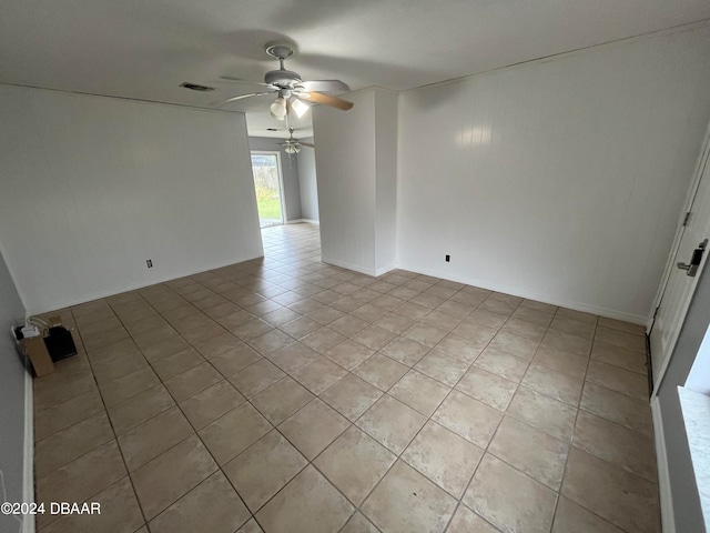 spare room with ceiling fan and light tile patterned floors