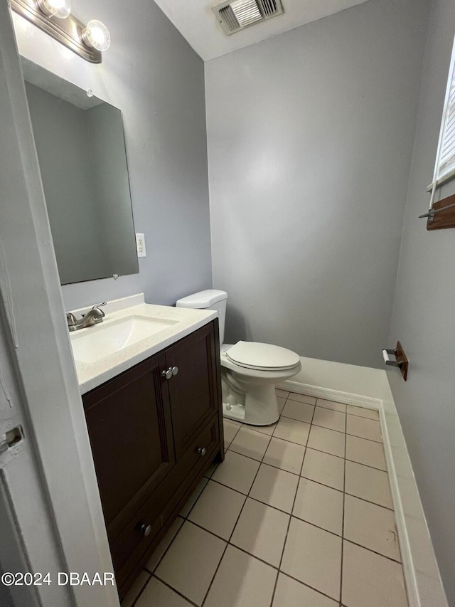 bathroom with vanity, tile patterned floors, and toilet