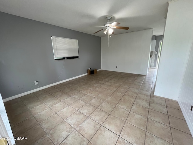 empty room featuring ceiling fan and light tile patterned floors