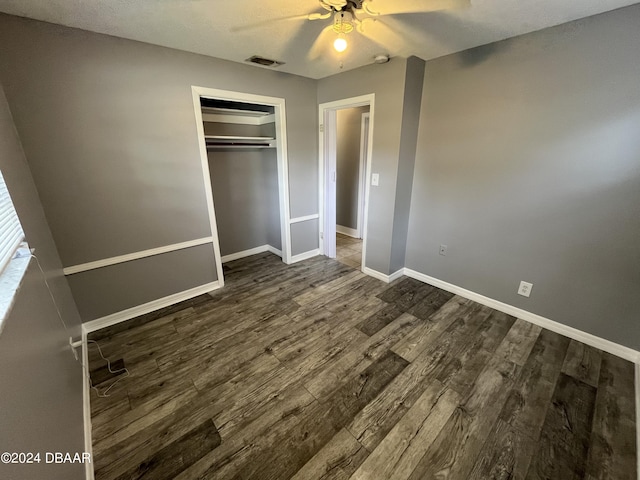 506 Cambridge Cir S, Daytona, FL 32119 - unfurnished bedroom featuring dark wood-type flooring, a ceiling fan, and a closet
