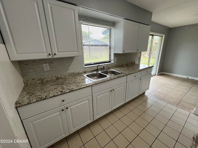 kitchen with plenty of natural light, sink, and white cabinets