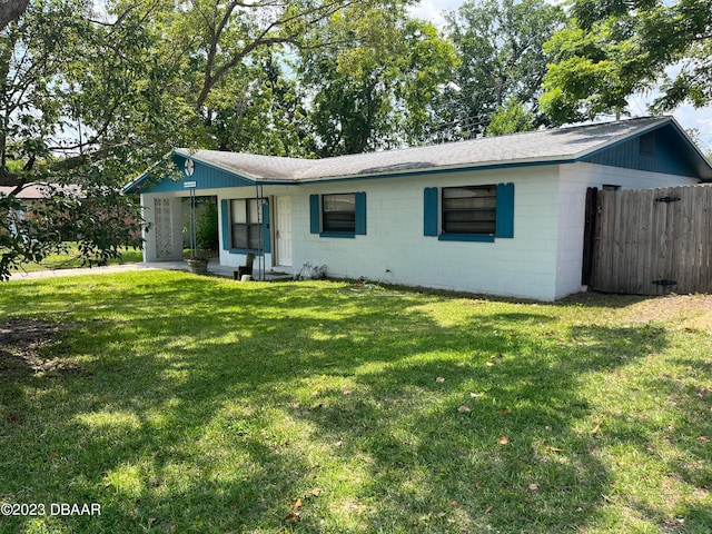 ranch-style house with a front lawn