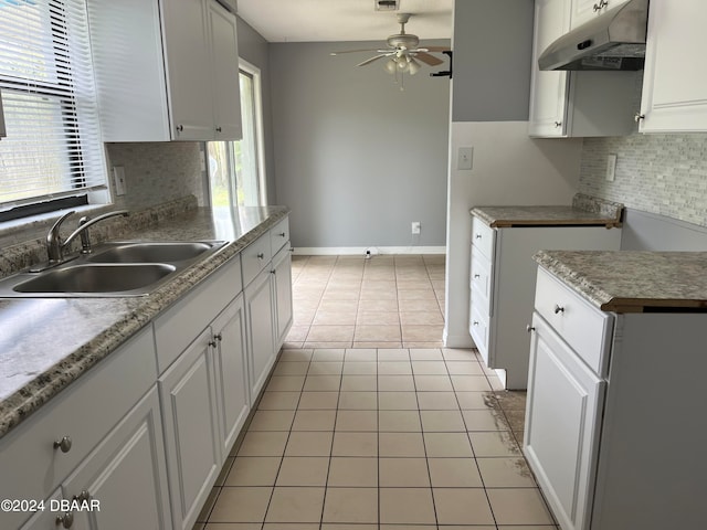 kitchen with light tile patterned floors, white cabinetry, and plenty of natural light