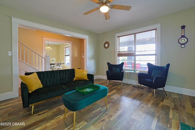 living room with ceiling fan and dark hardwood / wood-style flooring