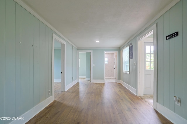 interior space featuring crown molding and light hardwood / wood-style floors