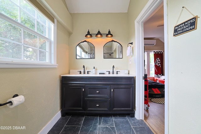 bathroom with vanity, plenty of natural light, and a wall unit AC