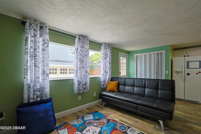 living room with dark hardwood / wood-style flooring and a textured ceiling