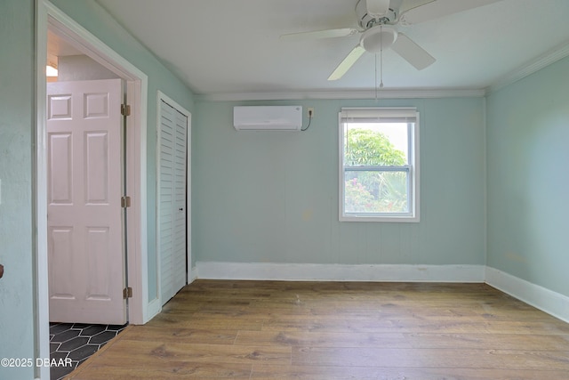 unfurnished room with crown molding, hardwood / wood-style floors, ceiling fan, and a wall unit AC