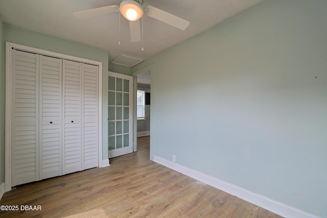 unfurnished bedroom featuring ceiling fan, light hardwood / wood-style floors, and a closet