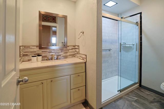 bathroom with an enclosed shower, backsplash, vanity, and toilet