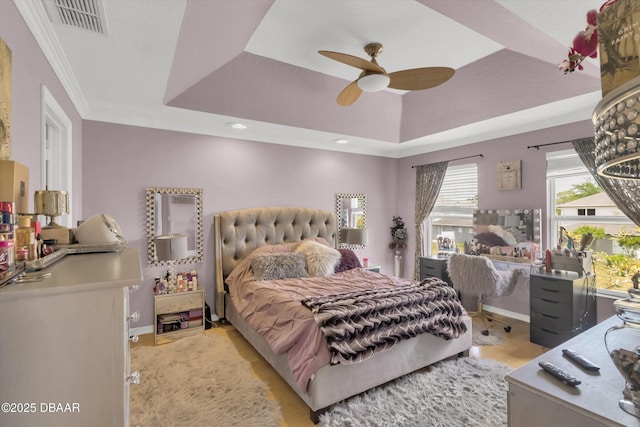 1767 Travertine Ter, Sanford, FL 32771 - bedroom with light wood finished floors, a tray ceiling, visible vents, baseboards, and ornamental molding