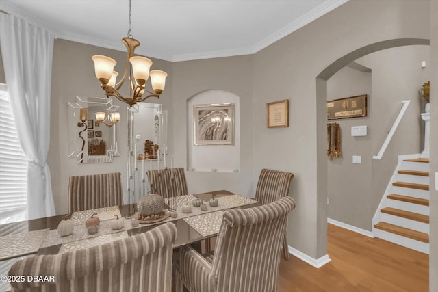 1767 Travertine Ter, Sanford, FL 32771 - dining room with crown molding, stairway, a chandelier, arched walkways, and wood finished floors