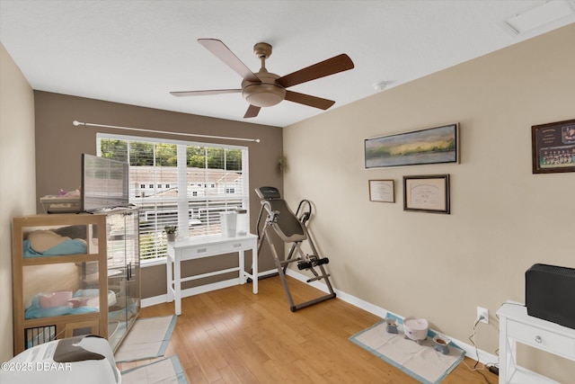 1767 Travertine Ter, Sanford, FL 32771 - exercise area featuring ceiling fan, light wood finished floors, and baseboards