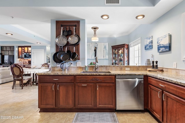 kitchen featuring crown molding, open floor plan, a sink, light stone countertops, and dishwasher