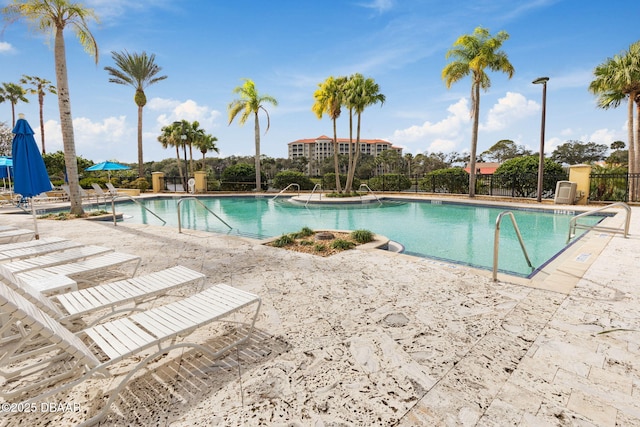 community pool featuring a patio area and fence