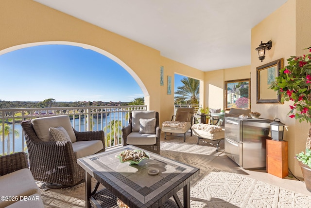 exterior space with a water view, outdoor lounge area, and a balcony