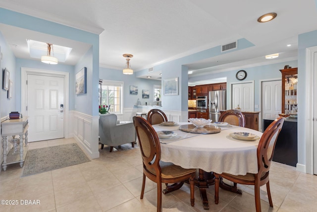 dining space with light tile patterned flooring, recessed lighting, visible vents, ornamental molding, and wainscoting