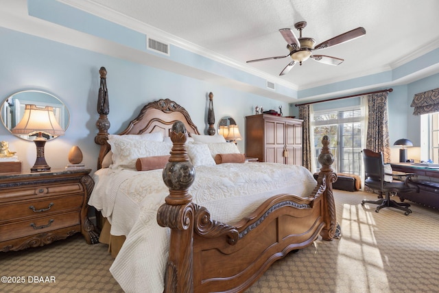 carpeted bedroom featuring visible vents, a raised ceiling, a ceiling fan, ornamental molding, and a textured ceiling