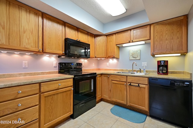 kitchen with a textured ceiling, black appliances, sink, and light tile patterned floors