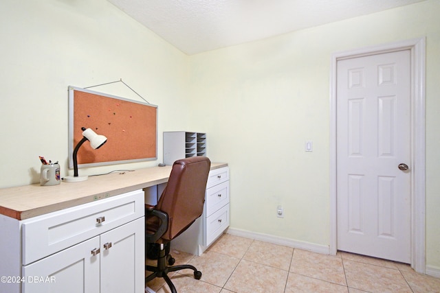 tiled home office with a textured ceiling