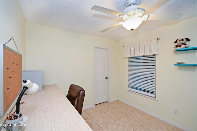 office featuring a textured ceiling, light tile patterned floors, and ceiling fan