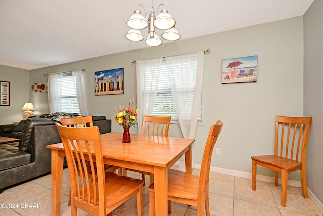 dining room with light tile patterned flooring and a notable chandelier