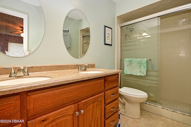 bathroom with toilet, vanity, an enclosed shower, and tile patterned floors