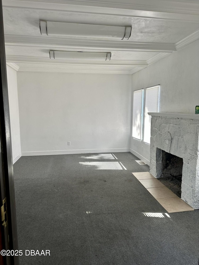 unfurnished living room featuring beamed ceiling, ornamental molding, carpet, and a fireplace