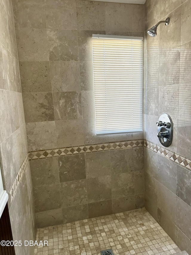 bathroom with tiled shower