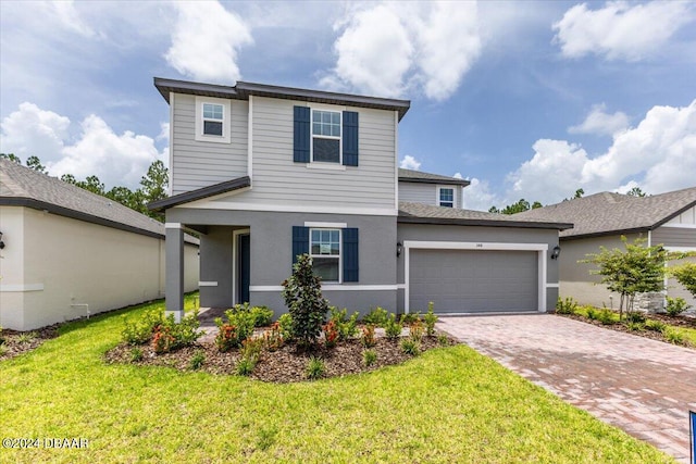 view of front property with a front yard and a garage