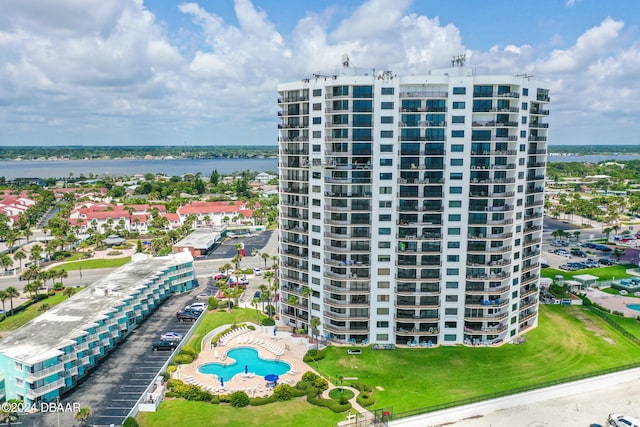 view of property featuring a water view and a community pool