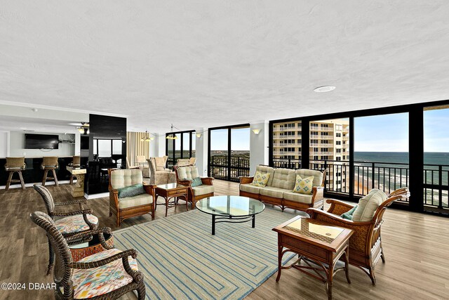 living area featuring a wall of windows and wood finished floors