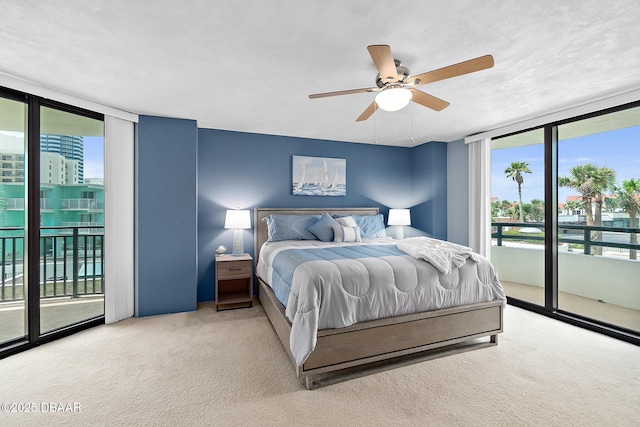 bedroom with floor to ceiling windows, carpet, access to exterior, and ceiling fan