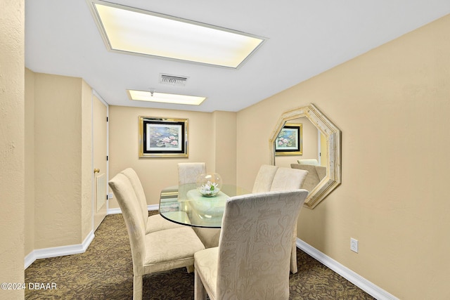 dining room with carpet and baseboards