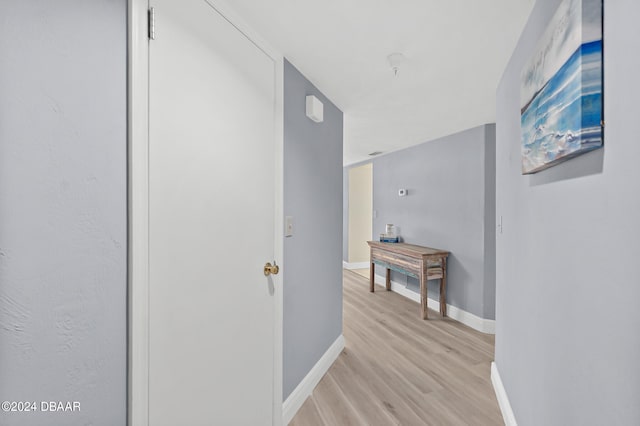 corridor with light hardwood / wood-style floors