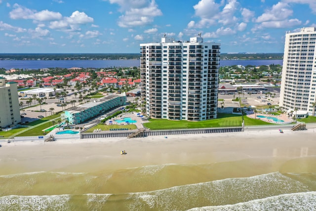 bird's eye view featuring a view of the beach and a water view