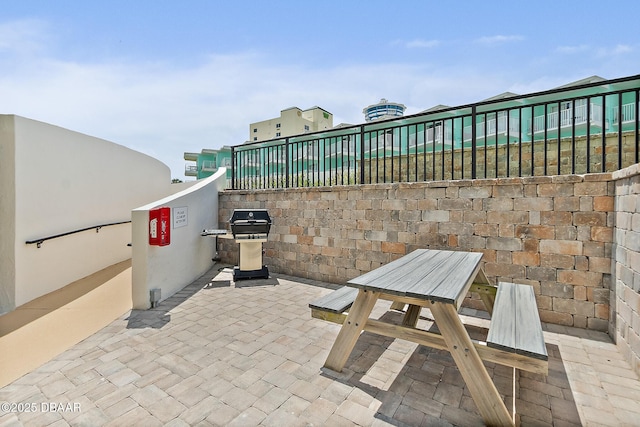 view of patio / terrace with area for grilling, outdoor dining space, and fence