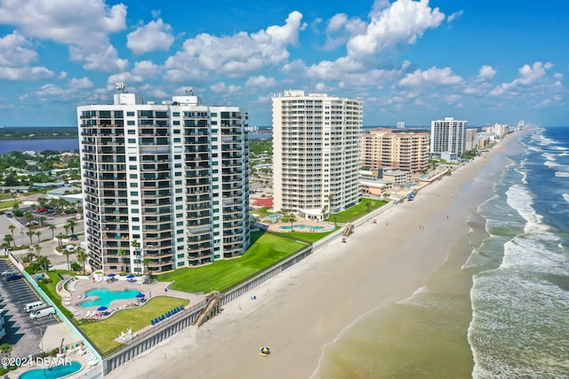 drone / aerial view featuring a water view and a beach view