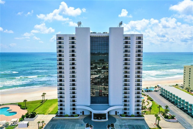 exterior space featuring a view of the beach and a water view