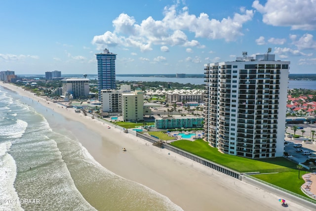 drone / aerial view featuring a beach view and a water view