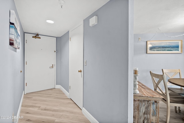 corridor with light hardwood / wood-style flooring