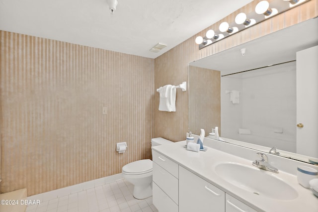 bathroom with vanity, tile patterned flooring, and toilet