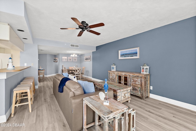 living room with light hardwood / wood-style floors and ceiling fan