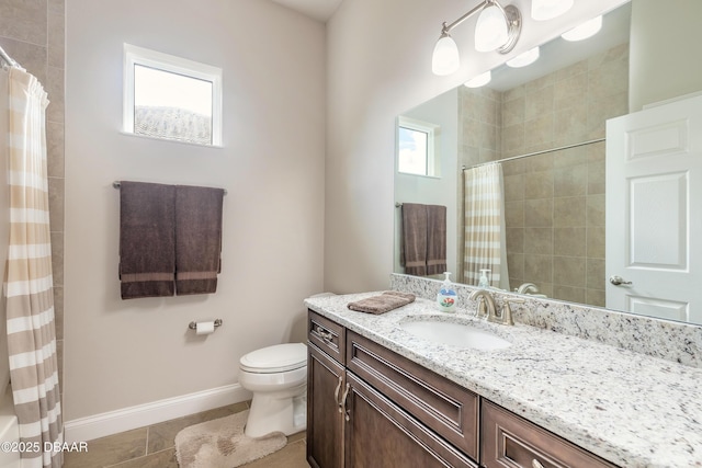 bathroom featuring toilet, tile patterned floors, walk in shower, and vanity