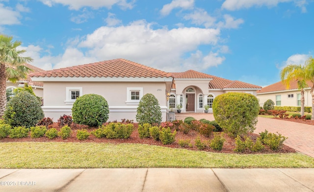 mediterranean / spanish-style home featuring a front lawn