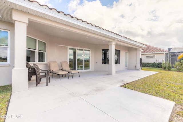 back of property featuring a yard and a patio