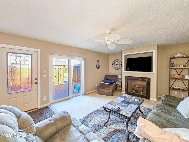 carpeted living area with a fireplace with flush hearth, baseboards, and a textured ceiling